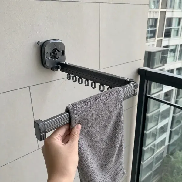 Towel drying on a Qinux Hangeroox mounted on a tiled wall next to a balcony door